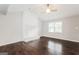 Bright living room featuring a vaulted ceiling, painted brick fireplace, and hardwood floors at 1590 Sw Cherry Hill Ln, Conyers, GA 30094