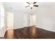 Spacious main bedroom with hardwood floors, ceiling fan, and adjoining ensuite bathroom at 1590 Sw Cherry Hill Ln, Conyers, GA 30094