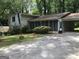 Traditional home with a carport, a screened in porch, and mature trees at 2017 Pine Cone Sw Dr, Atlanta, GA 30331