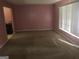 Living room with light pink walls and a window at 2017 Pine Cone Sw Dr, Atlanta, GA 30331