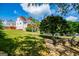 Spacious backyard view showcasing lush greenery, fire pit with seating, and the home's exterior with a large deck at 1745 Stripling Chapel Rd, Carrollton, GA 30116