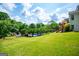 Lush backyard featuring a well-maintained lawn, mature trees, and a glimpse of the inviting swimming pool at 1745 Stripling Chapel Rd, Carrollton, GA 30116