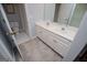 Modern bathroom with double sinks, white cabinets, and tile flooring at 1745 Stripling Chapel Rd, Carrollton, GA 30116