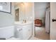 A charming Bedroom is just beyond this bathroom featuring a classic white vanity and neutral decor at 1745 Stripling Chapel Rd, Carrollton, GA 30116