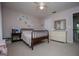 Comfortable bedroom with light pink walls and a floral wall design, complete with a queen bed and matching dresser at 1745 Stripling Chapel Rd, Carrollton, GA 30116