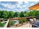 Deck featuring outdoor dining area, barbecue, and a serene backdrop of lush trees at 1745 Stripling Chapel Rd, Carrollton, GA 30116