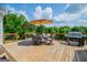 Outdoor deck with an umbrella, dining area, barbecue grill and scenic view at 1745 Stripling Chapel Rd, Carrollton, GA 30116