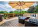 Outdoor deck area with comfortable seating and a large umbrella for shade at 1745 Stripling Chapel Rd, Carrollton, GA 30116