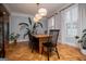 Elegant dining room with herringbone floors, modern chandelier, and large windows with plantation shutters at 1745 Stripling Chapel Rd, Carrollton, GA 30116