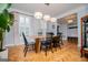 Refined dining area with wood flooring, sleek light fixtures, and ample natural light from large windows at 1745 Stripling Chapel Rd, Carrollton, GA 30116