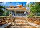 Back of house with stone steps and wrought iron fence leading up to a wooden deck at 1745 Stripling Chapel Rd, Carrollton, GA 30116