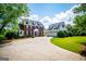 Lovely brick and siding two-story home with attached garage and a circular driveway and well-manicured lawn at 1745 Stripling Chapel Rd, Carrollton, GA 30116