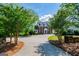 Beautiful two-story home with a circular driveway, surrounded by lush landscaping and mature trees at 1745 Stripling Chapel Rd, Carrollton, GA 30116