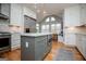 Kitchen with white cabinets, an island, stainless steel appliances, and an adjacent breakfast area at 1745 Stripling Chapel Rd, Carrollton, GA 30116