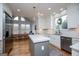 Updated kitchen with white cabinets, stainless steel appliances, island, and a breakfast nook near the windows at 1745 Stripling Chapel Rd, Carrollton, GA 30116