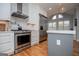 Modern kitchen with stainless steel appliances, island with seating, and white marble backsplash at 1745 Stripling Chapel Rd, Carrollton, GA 30116