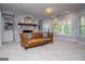 Inviting living room features a stone fireplace, built-in shelving, and large windows at 1745 Stripling Chapel Rd, Carrollton, GA 30116