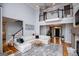 Spacious living room featuring a white sectional, hardwood floors, and views to the upper level at 1745 Stripling Chapel Rd, Carrollton, GA 30116