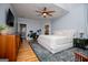 Open, airy main bedroom with a ceiling fan, area rug, and hardwood floors at 1745 Stripling Chapel Rd, Carrollton, GA 30116