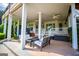 Covered patio with ceiling fans and seating area overlooking backyard at 1745 Stripling Chapel Rd, Carrollton, GA 30116