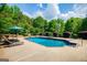 In ground pool surrounded by lawn chairs, trimmed bushes, and metal fencing at 1745 Stripling Chapel Rd, Carrollton, GA 30116