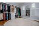Spacious walk-in closet featuring custom shelving and storage and a large round area rug at 1745 Stripling Chapel Rd, Carrollton, GA 30116