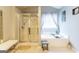 Bright bathroom showcases a soaking tub, separate shower, and elegant fixtures for relaxation at 1144 Simonton Hill Ct, Lawrenceville, GA 30045