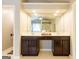 Bathroom with a double vanity featuring dark wood cabinetry, sinks, and large mirrors at 1144 Simonton Hill Ct, Lawrenceville, GA 30045