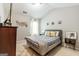 Bright bedroom with a gray bed frame, decorative wall hangings, and soft lighting for a peaceful retreat at 1144 Simonton Hill Ct, Lawrenceville, GA 30045