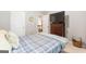 Comfortable bedroom with a plaid comforter, a dark wood dresser, and neutral walls creating a relaxing atmosphere at 1144 Simonton Hill Ct, Lawrenceville, GA 30045