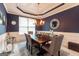 Elegant dining room with dark wood table, stylish chairs, wainscoting, and an ornate chandelier at 1144 Simonton Hill Ct, Lawrenceville, GA 30045