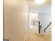 Bright hallway leads to the upper level, featuring neutral tones and a view of the staircase at 1144 Simonton Hill Ct, Lawrenceville, GA 30045