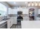 A spacious kitchen with stainless steel appliances, white cabinets, and a large island perfect for entertaining at 1144 Simonton Hill Ct, Lawrenceville, GA 30045