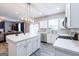 Open-concept kitchen with a large center island, white cabinets, and stainless steel appliances; great for gatherings at 1144 Simonton Hill Ct, Lawrenceville, GA 30045