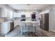 Bright kitchen with stainless steel appliances, white cabinets, and a large island at 1144 Simonton Hill Ct, Lawrenceville, GA 30045