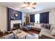 Cozy living room featuring a fireplace, hardwood floors, and comfortable seating at 1144 Simonton Hill Ct, Lawrenceville, GA 30045