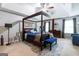 Comfortable main bedroom with a four-poster bed, ceiling fan, and cozy sitting area at 1144 Simonton Hill Ct, Lawrenceville, GA 30045