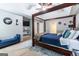 Spacious main bedroom features a four-poster bed, ceiling fan, and ample natural light at 1144 Simonton Hill Ct, Lawrenceville, GA 30045