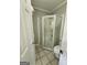Bathroom featuring a corner shower with glass doors and tile flooring at 3581 S Hwy 100, Bowdon, GA 30108