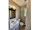 Bathroom with tiled floors, white vanity, and tile surround shower at 3581 S Hwy 100, Bowdon, GA 30108