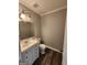 Cozy bathroom with gray walls, wood-look floors, and white vanity at 3581 S Hwy 100, Bowdon, GA 30108