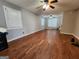 Spacious living room featuring hardwood floors and two ceiling fans at 3581 S Hwy 100, Bowdon, GA 30108