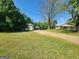 Expansive property showcasing the house and outbuilding surrounded by lush greenery at 3581 S Hwy 100, Bowdon, GA 30108