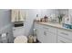 Updated bathroom with granite counters, white cabinets, and decorative towel racks at 6324 Amberly Rd, Rex, GA 30273
