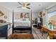 Traditional style main bedroom featuring a four-poster bed, ceiling fan and unique decor at 6324 Amberly Rd, Rex, GA 30273