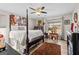 Spacious bedroom with a four-poster bed, ceiling fan, and a warm, inviting ambiance at 6324 Amberly Rd, Rex, GA 30273