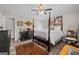 Comfortable bedroom featuring a four-poster bed, ceiling fan, and laminate wood-look flooring at 6324 Amberly Rd, Rex, GA 30273