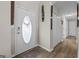 Inviting foyer with a front door with decorative window and wood-look laminate flooring at 6324 Amberly Rd, Rex, GA 30273