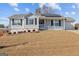 Charming one-story home featuring a cozy front porch, well-maintained landscaping, and a two-car garage at 6324 Amberly Rd, Rex, GA 30273