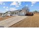 Beautiful one-story home with a long driveway, a welcoming front porch, and a two-car garage at 6324 Amberly Rd, Rex, GA 30273